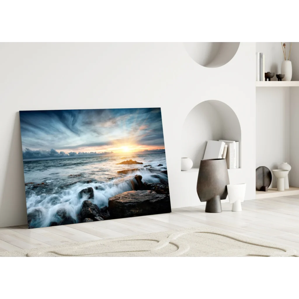 Dramatic ocean sunset glass wall art with crashing waves on rocky shores
