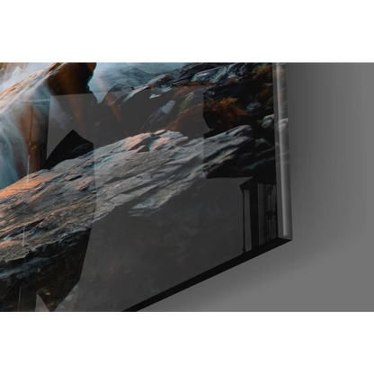 Sleek glass wall art of ocean sunset with crashing waves and foliage