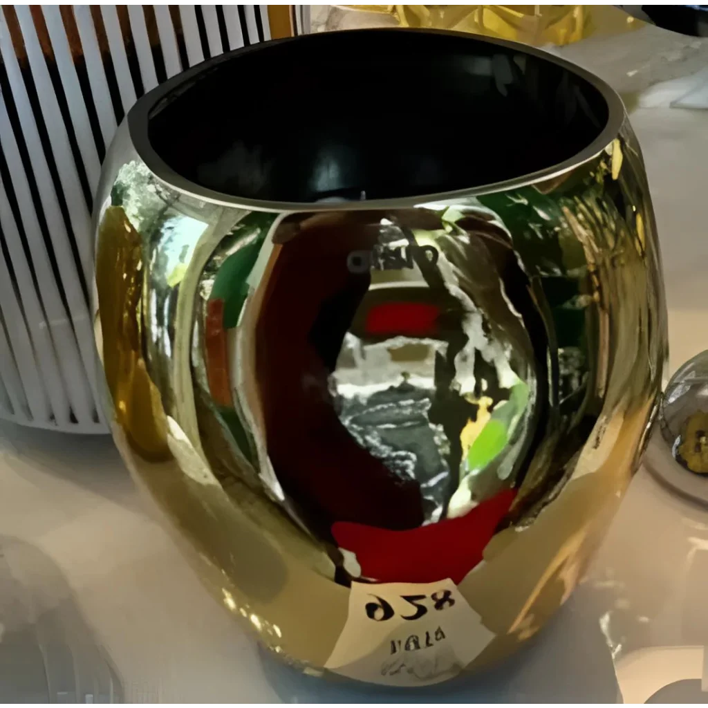 Golden Onno Cape metallic candle container with a shiny reflective finish and black interior