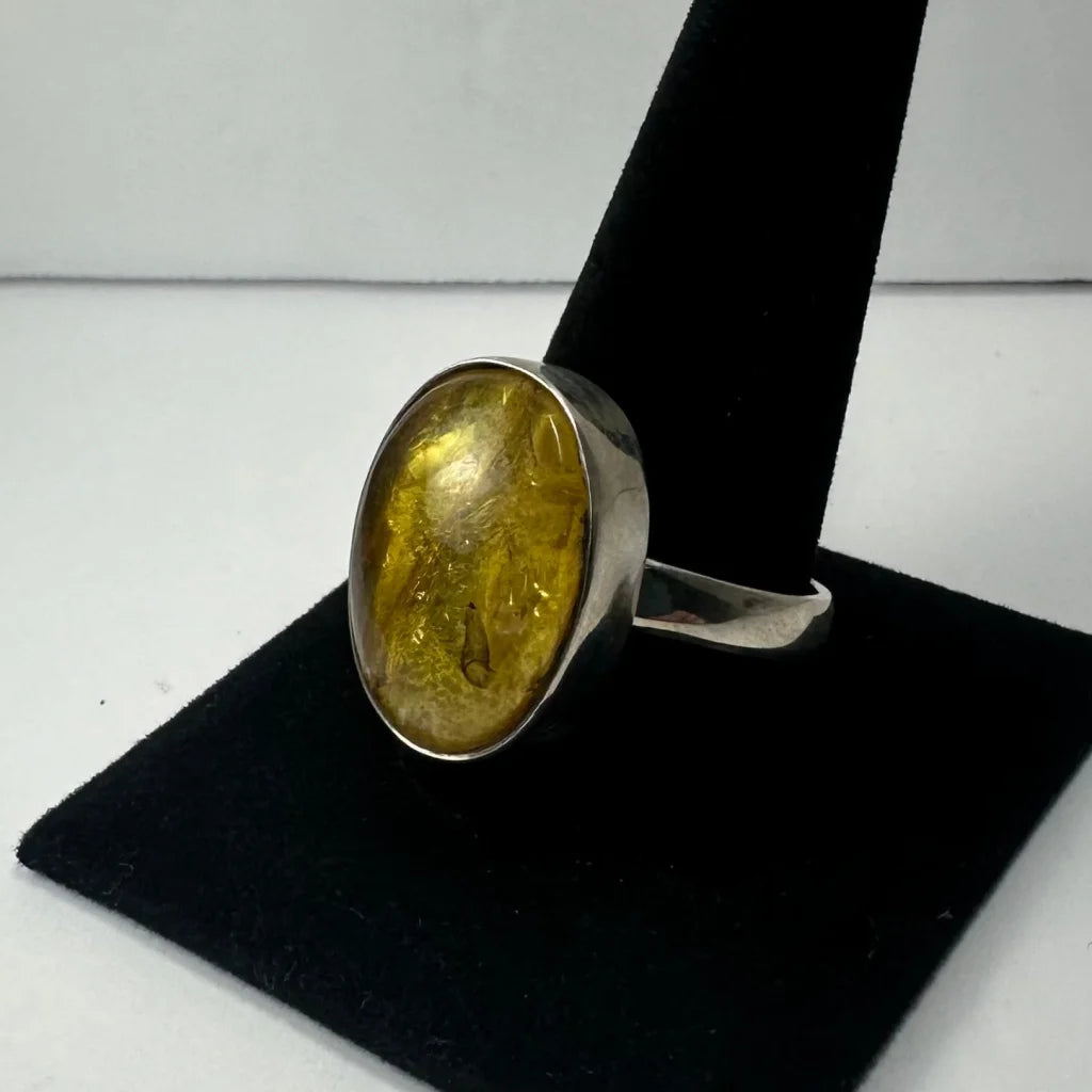 Stunning oval amber ring with golden glow on silver band