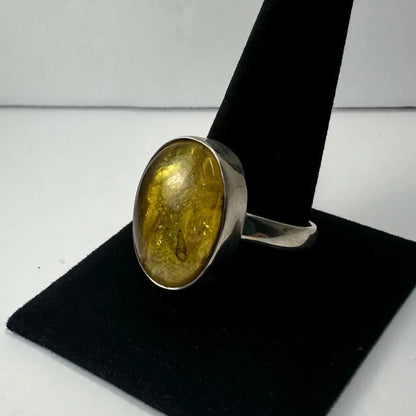 Stunning oval amber ring with golden glow on silver band