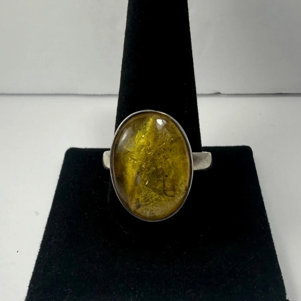 Stunning oval amber ring with golden glow on silver band