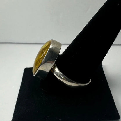 Bold silver amber ring with oval stone and golden glow