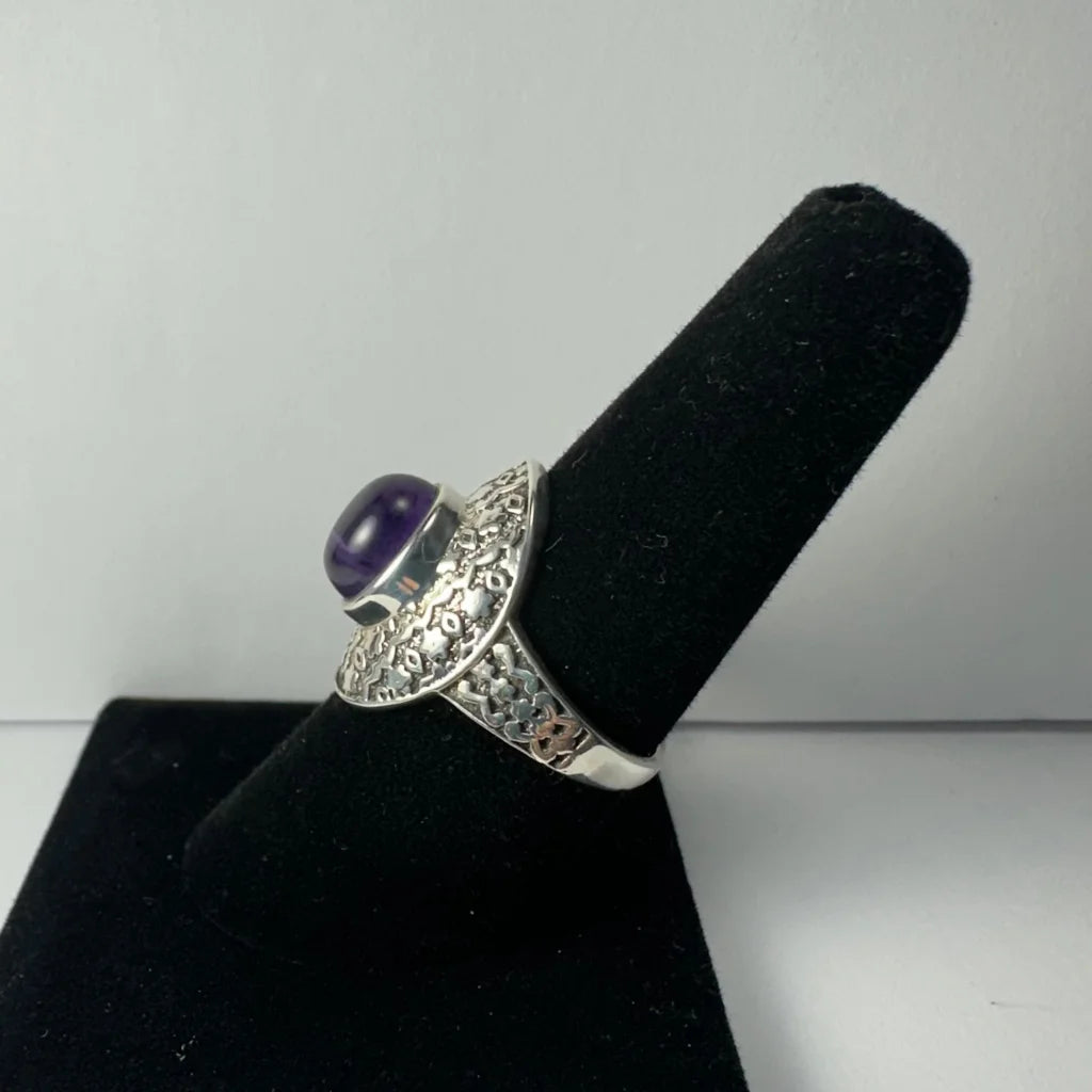 Stunning silver amethyst ring with ornate filigree band and oval purple gem