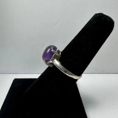 Sleek sterling silver amethyst ring with oval purple gem in prong setting