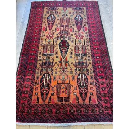 Stunning Persian Baluch rug with intricate geometric patterns and luxurious wool pile