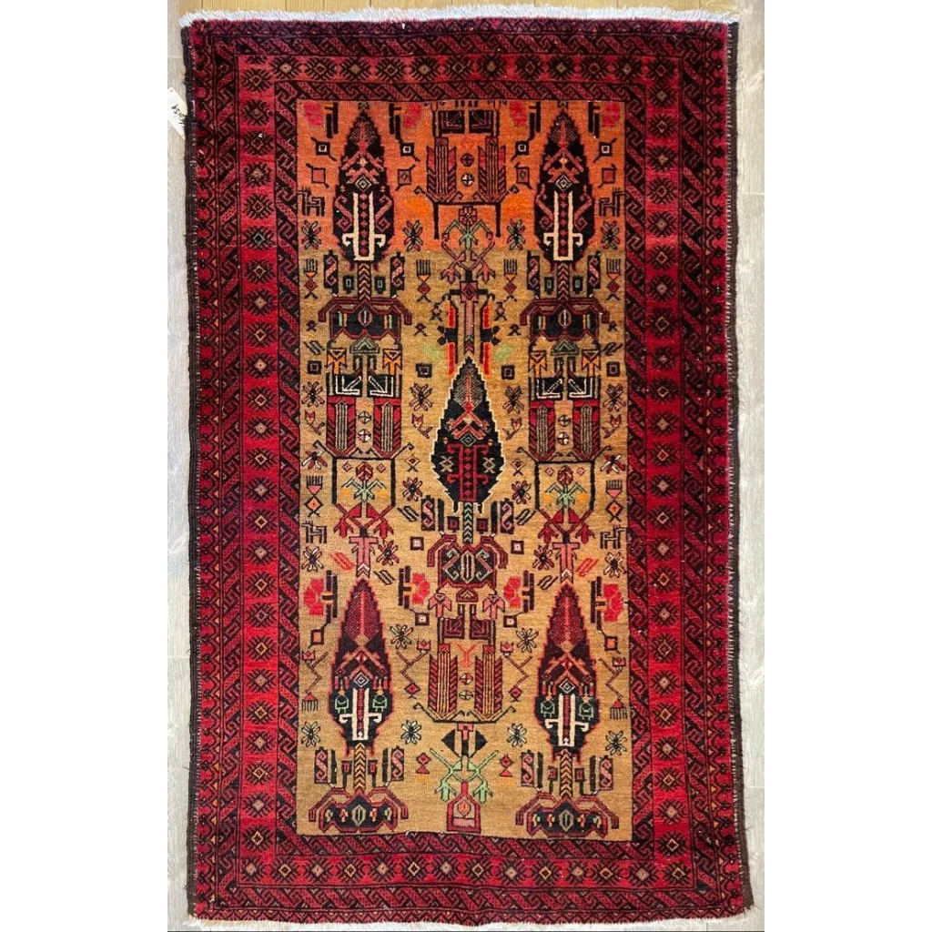 Vintage 1970s Persian Baluch rug with rich red border and geometric patterns in orange, black, beige and green