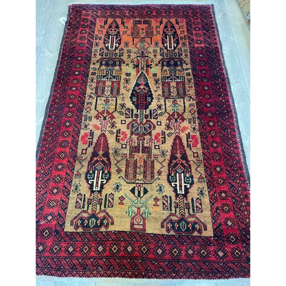 Vintage 1970s Persian Baluch rug with intricate geometric patterns in natural wool pile