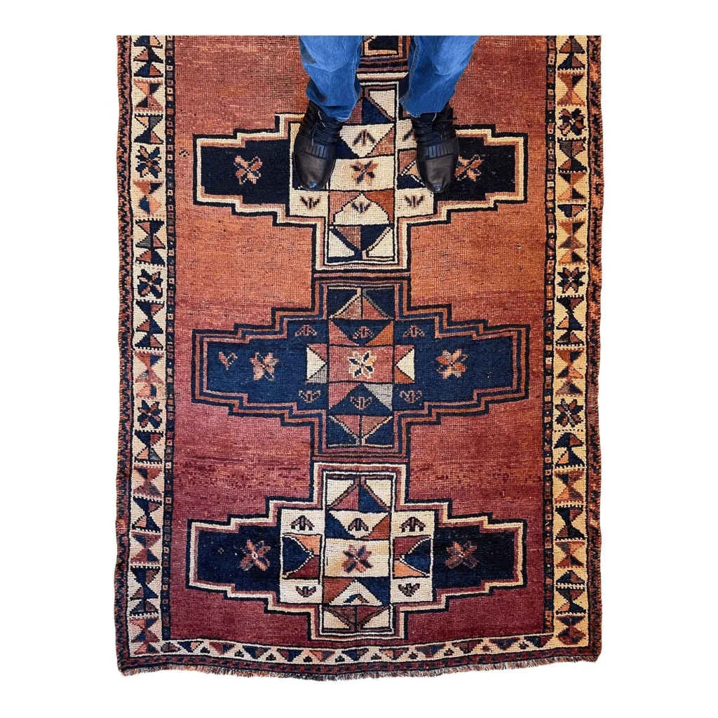Stunning Persian Luri tribal runner rug in rust-red with navy and cream geometrics