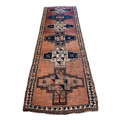 Vintage Persian Luri tribal runner rug with bold geometric patterns in orange, red, navy and cream