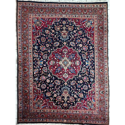 Stunning Persian Mashhad hand knotted wool area rug with navy blue field