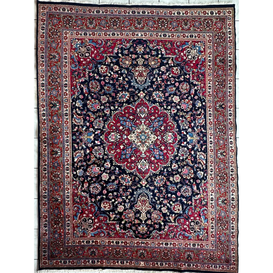 Stunning Persian Mashhad hand knotted wool area rug with navy blue field