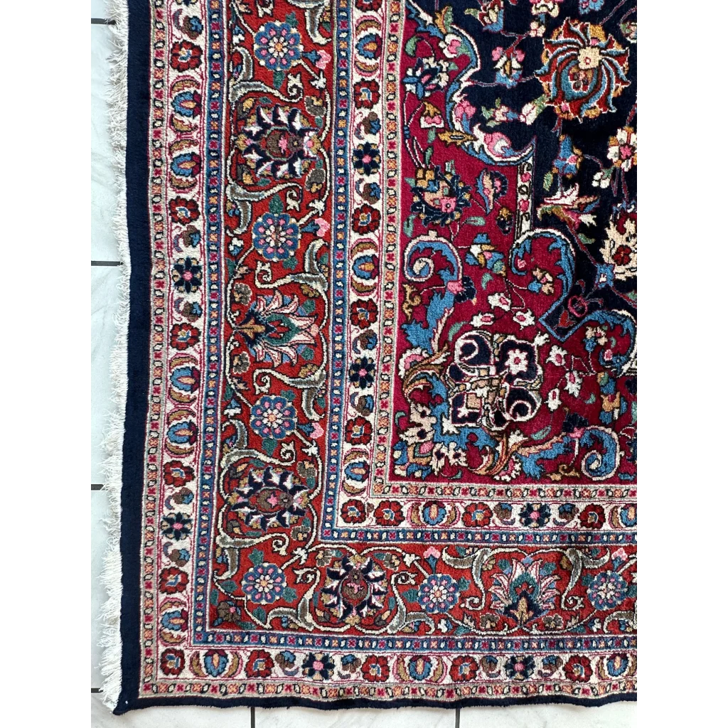 Stunning Persian Mashhad hand knotted wool area rug with red field and floral patterns