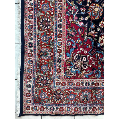 Stunning Persian Mashhad hand knotted wool area rug with red field and floral patterns