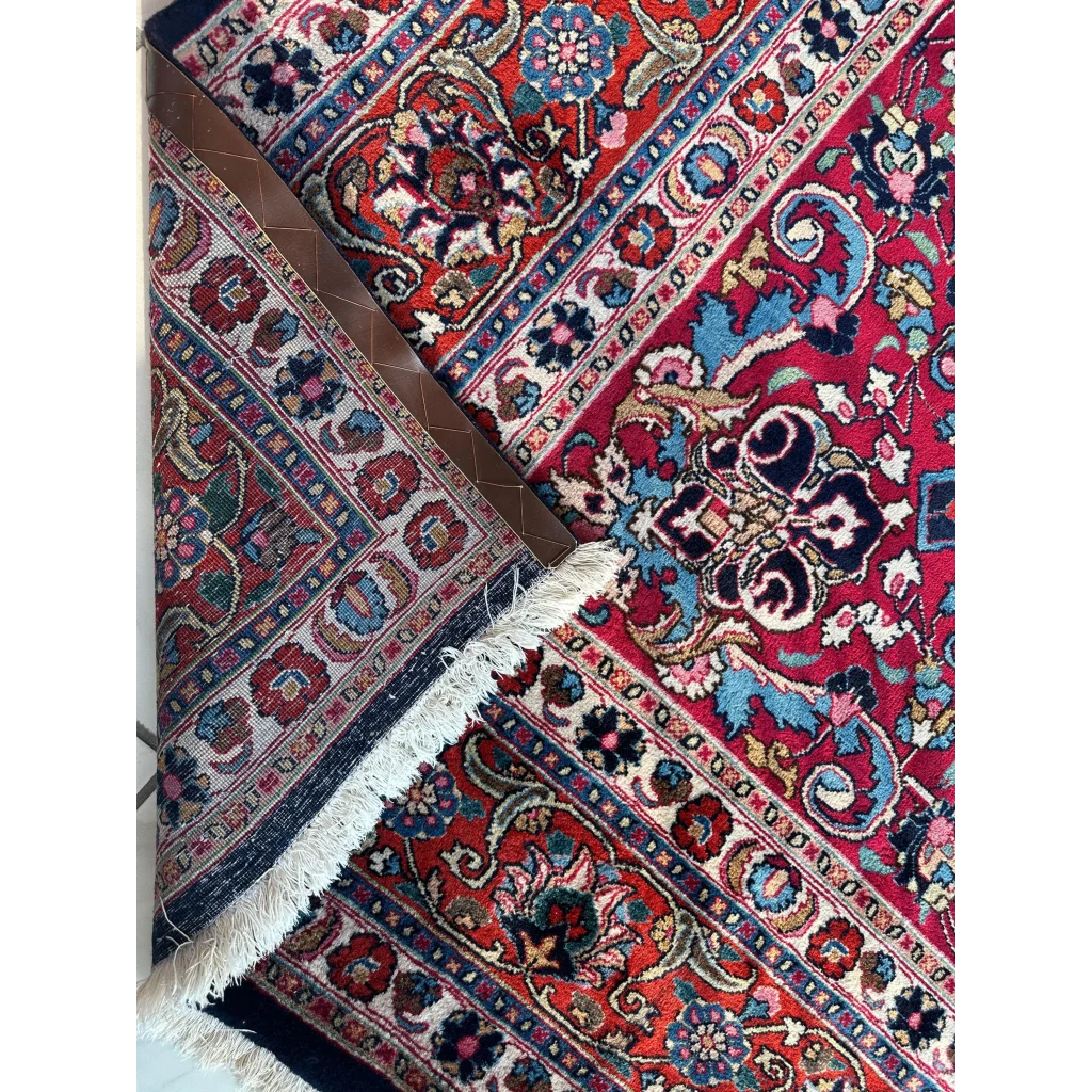 Vibrant red Persian Mashhad hand knotted wool area rug with intricate floral patterns