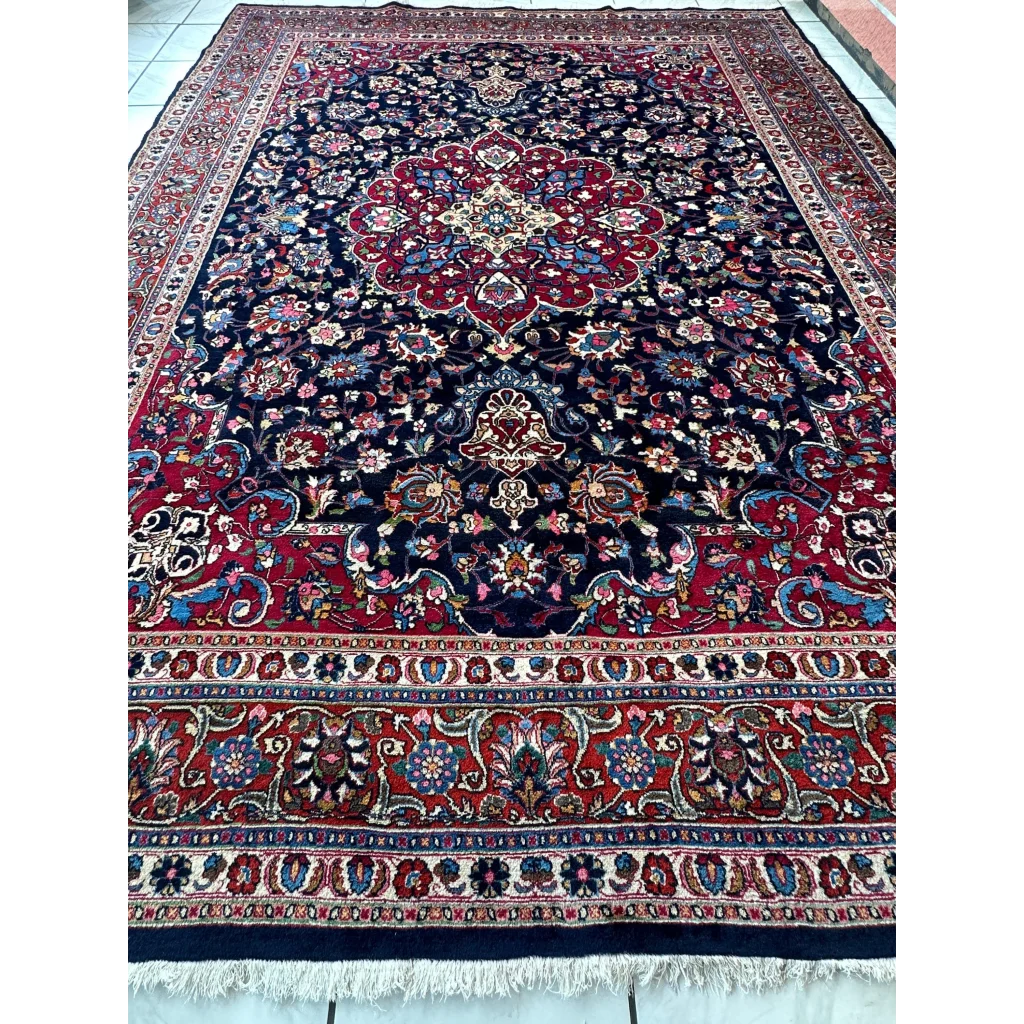 Stunning Persian Mashhad hand knotted wool area rug with navy floral patterns