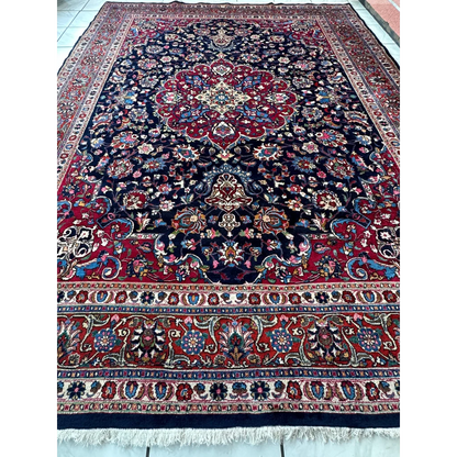 Stunning Persian Mashhad hand knotted wool area rug with navy floral patterns