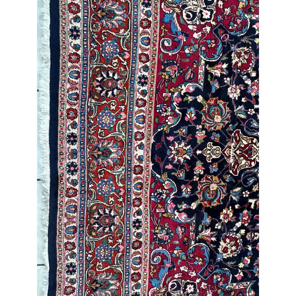 Stunning Persian Mashhad hand knotted wool area rug with intricate floral paisley patterns in deep red navy blue and gold