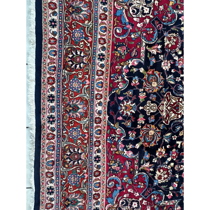 Stunning Persian Mashhad hand knotted wool area rug with intricate floral paisley patterns in deep red navy blue and gold
