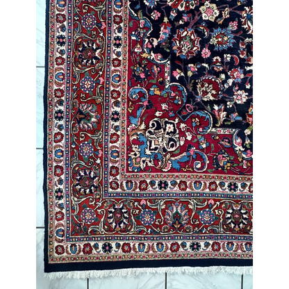 Stunning Persian Mashhad hand knotted wool area rug with red navy floral motifs
