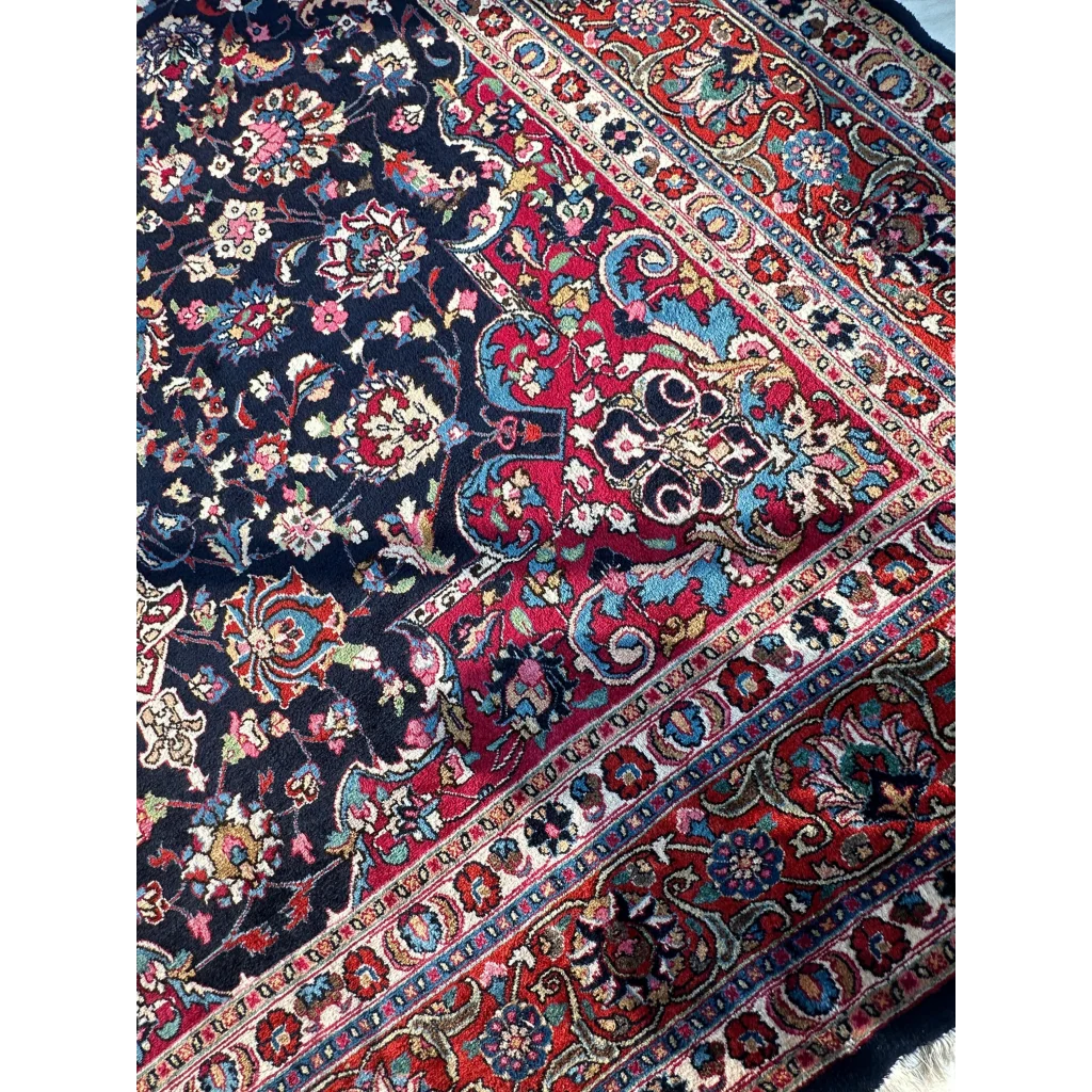 Stunning Persian Mashhad hand knotted wool area rug with navy red floral motifs
