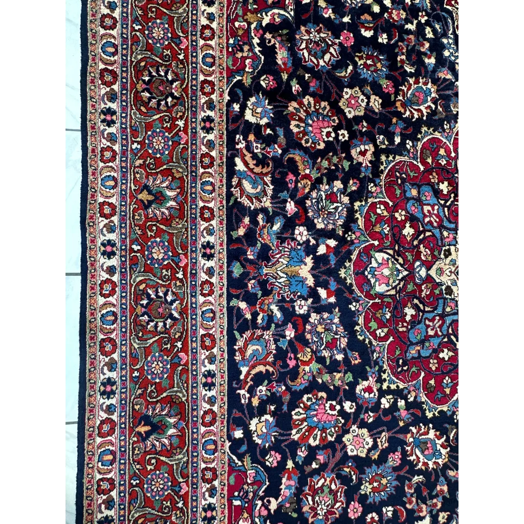 Stunning Persian Mashhad hand knotted wool area rug with navy floral patterns