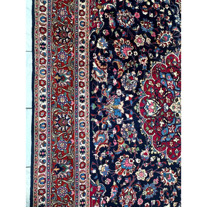 Stunning Persian Mashhad hand knotted wool area rug with navy floral patterns