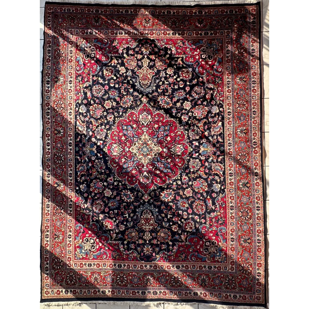 Stunning Persian Mashhad hand knotted wool area rug with red navy medallion