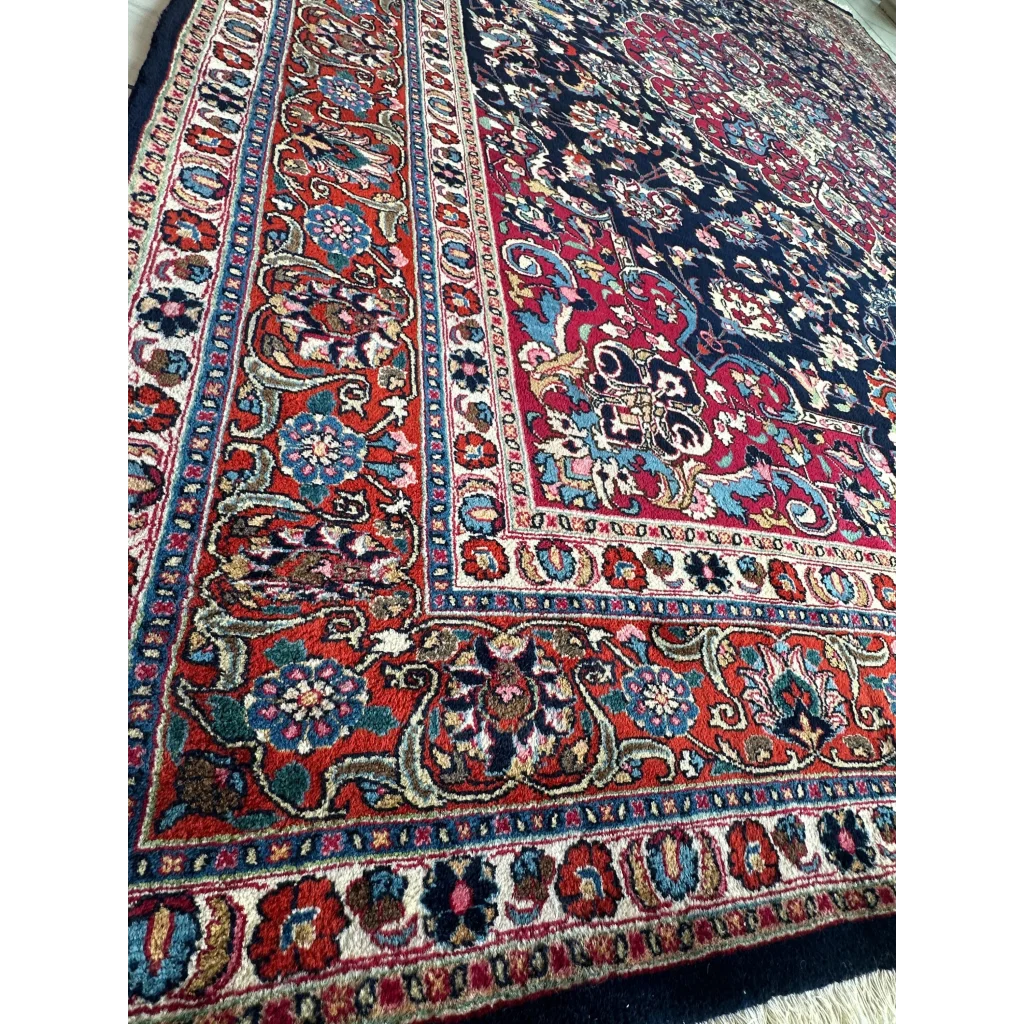Stunning Persian Mashhad hand knotted wool area rug with intricate floral patterns