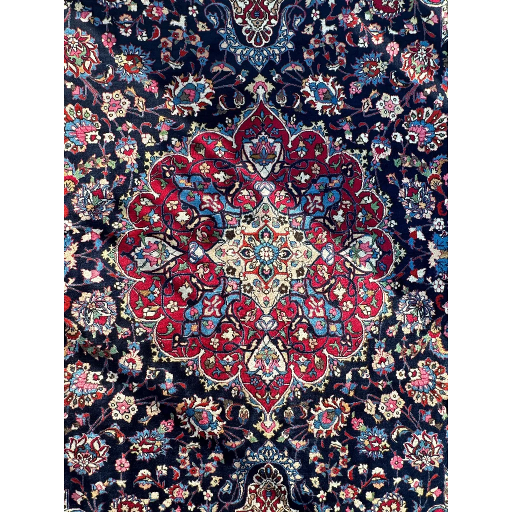 Stunning Persian Mashhad hand knotted wool area rug with central red medallion