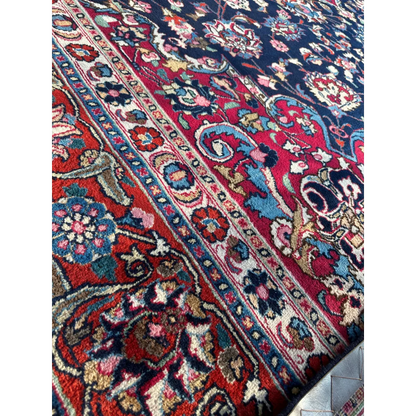 Stunning Persian Mashhad hand knotted wool area rug with intricate floral paisley patterns in deep red navy blue gold turquoise