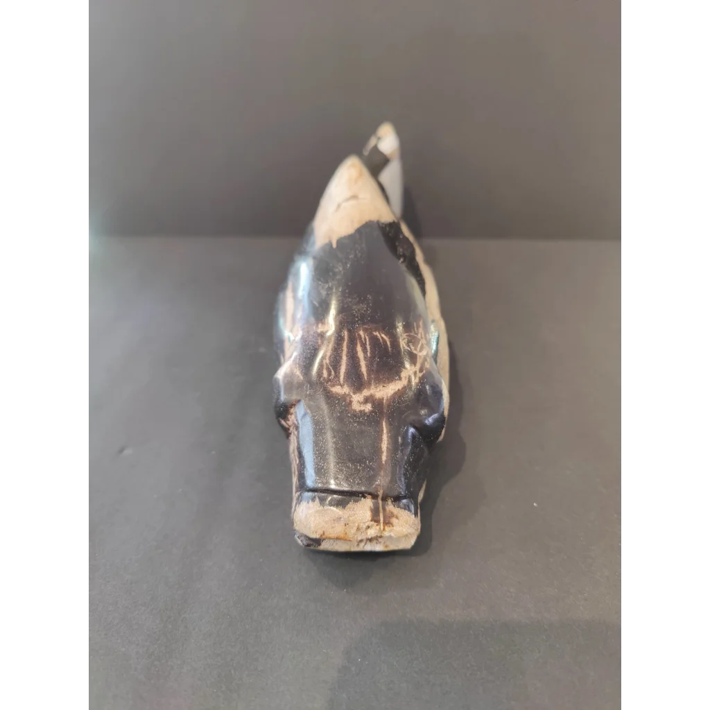 Stylized petrified wood fish sculpture in black and white ceramic