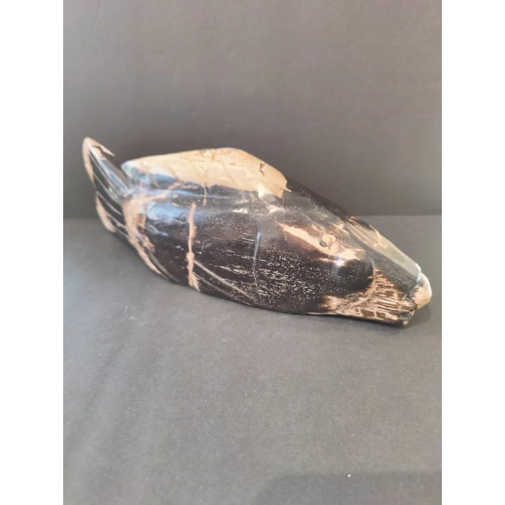 Polished black and cream marble duck sculpture in petrified wood style