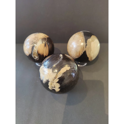 Three marbled black and cream agate petrified wood spheres