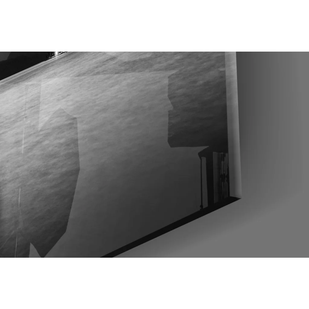 Black and white geometric abstract glass wall art with moody skies