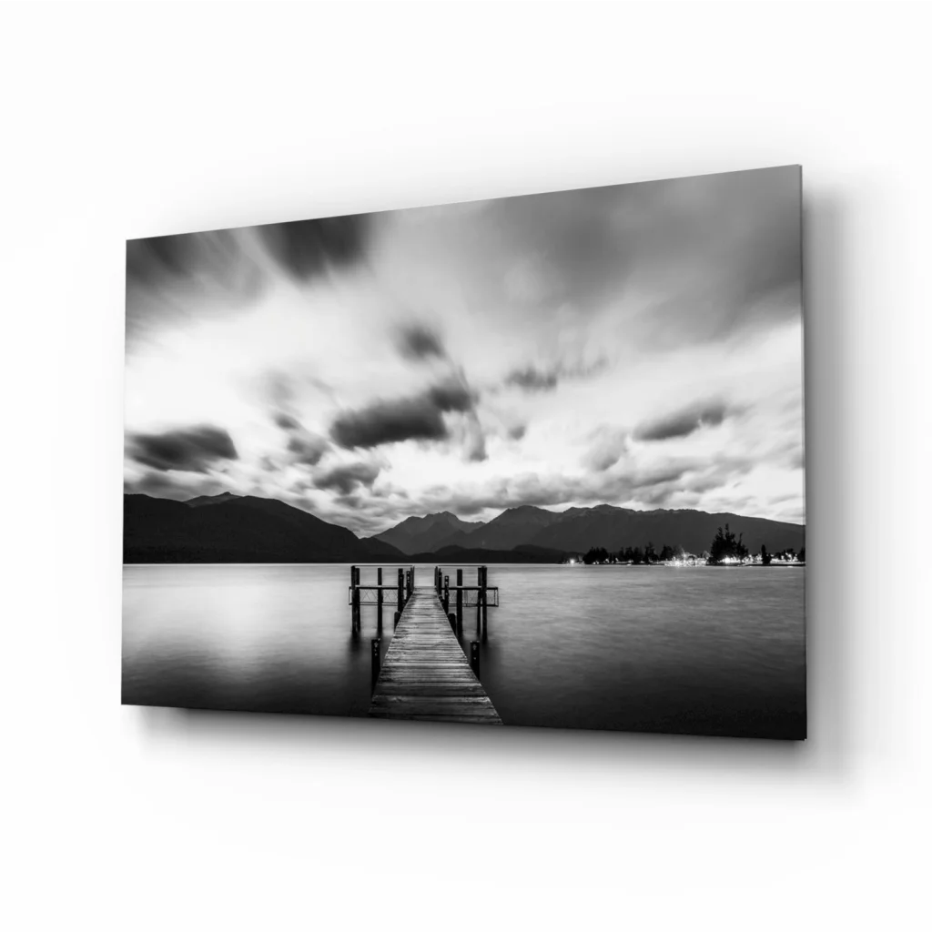 Stunning wooden pier glass wall art with moody skies and mountains