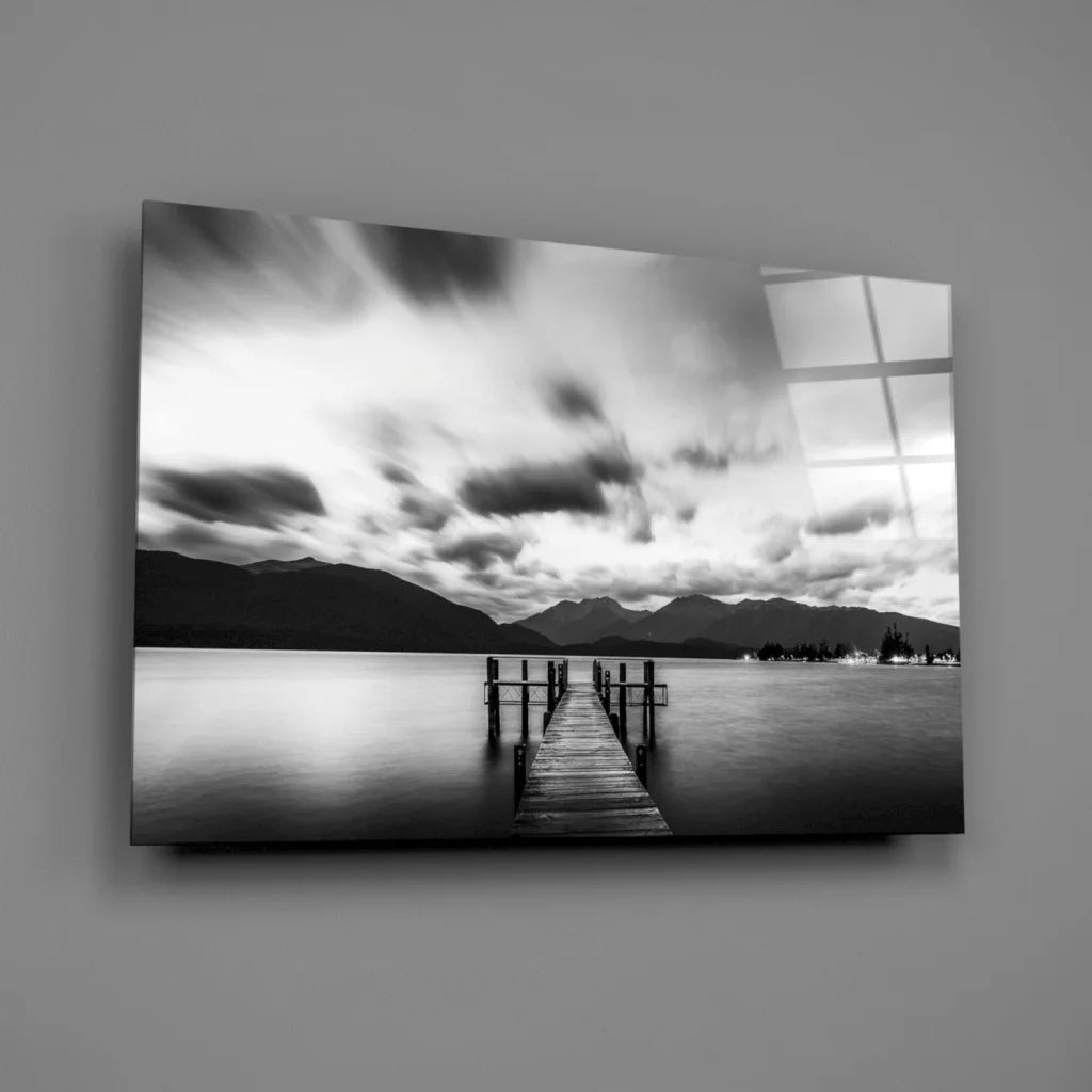 Black and white pier in stunning glass wall art with moody skies