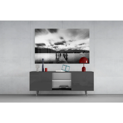 Modern black and white wooden sideboard with sleek drawers and glass wall art