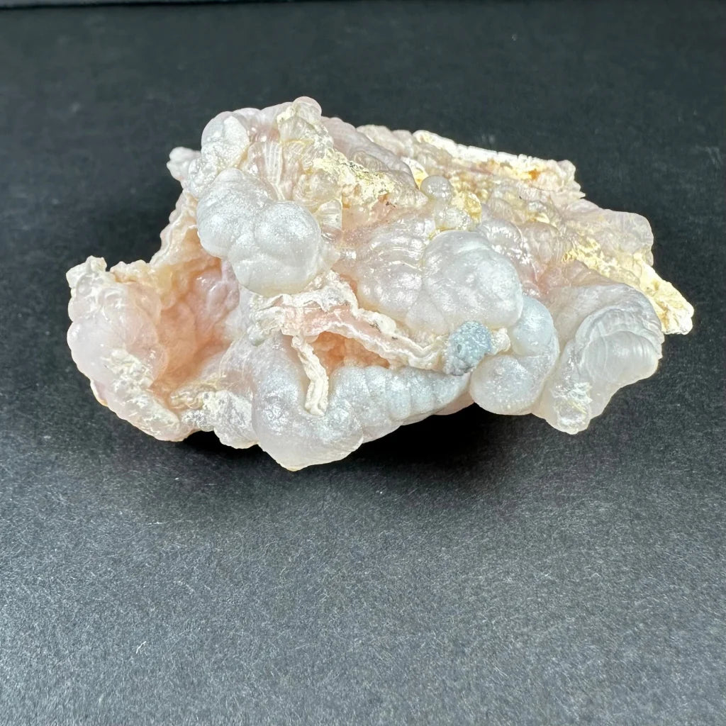 Stunning pink opal Ica geode with translucent pink layers and golden inclusions