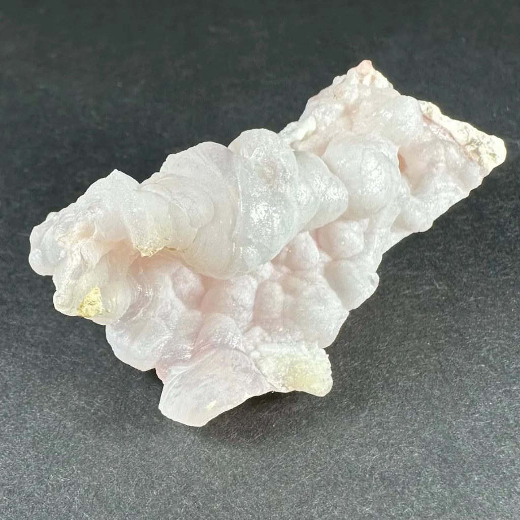 Stunning pink opal Ica geode with translucent pale pink layers and golden inclusions