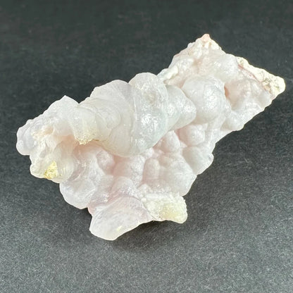 Stunning pink opal Ica geode with translucent pale pink layers and golden inclusions