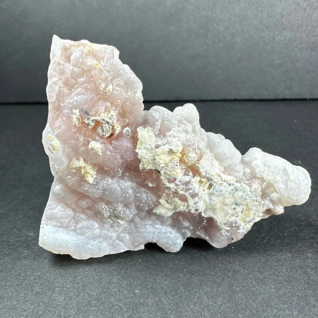 Stunning pink opal Ica geode with translucent pink-white crystals and gold patches