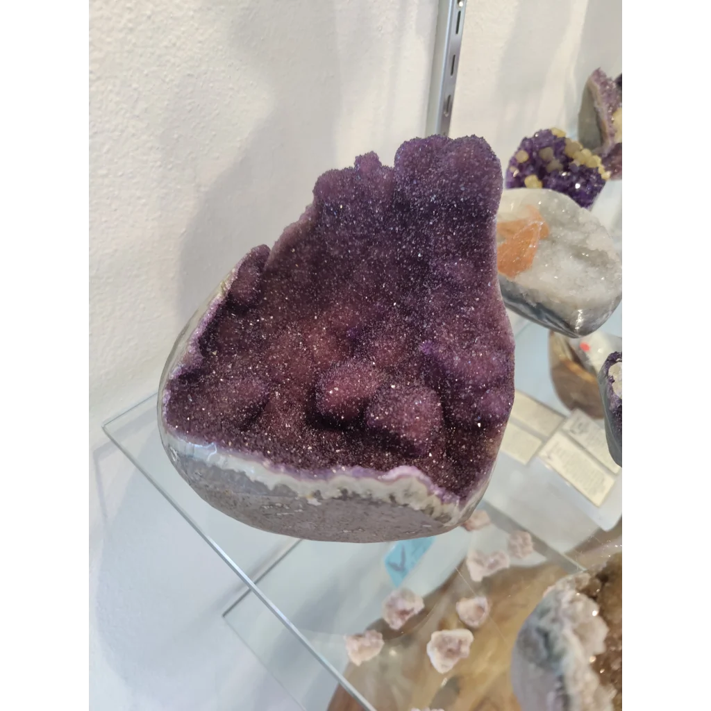 Stunning purple amethyst geode sculpture with sparkling crystals