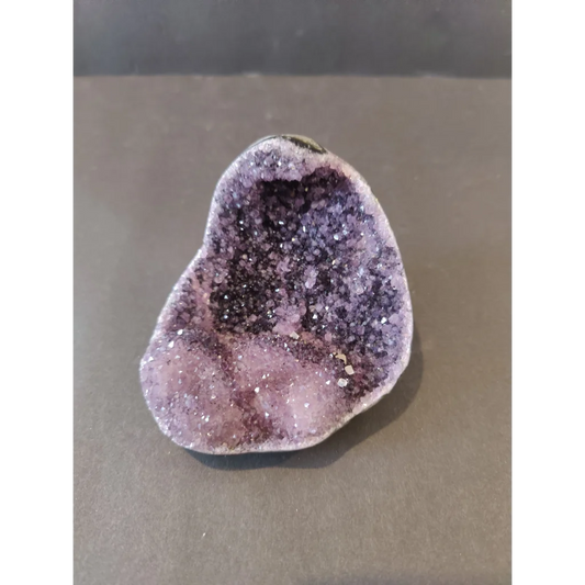 Stunning purple amethyst geode sculpture with calcite crystal inclusions from Brazil