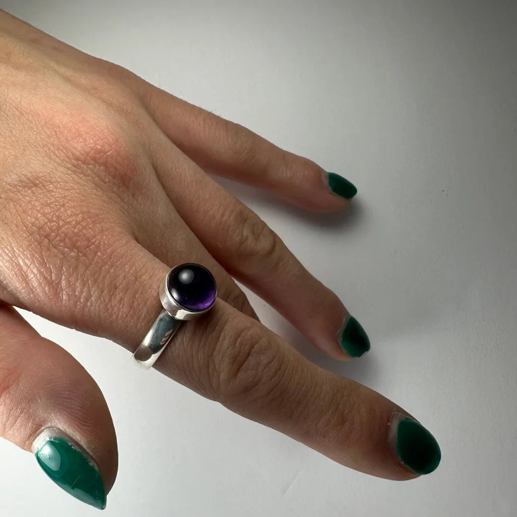 Sleek silver amethyst ring with deep purple stone in minimalist band