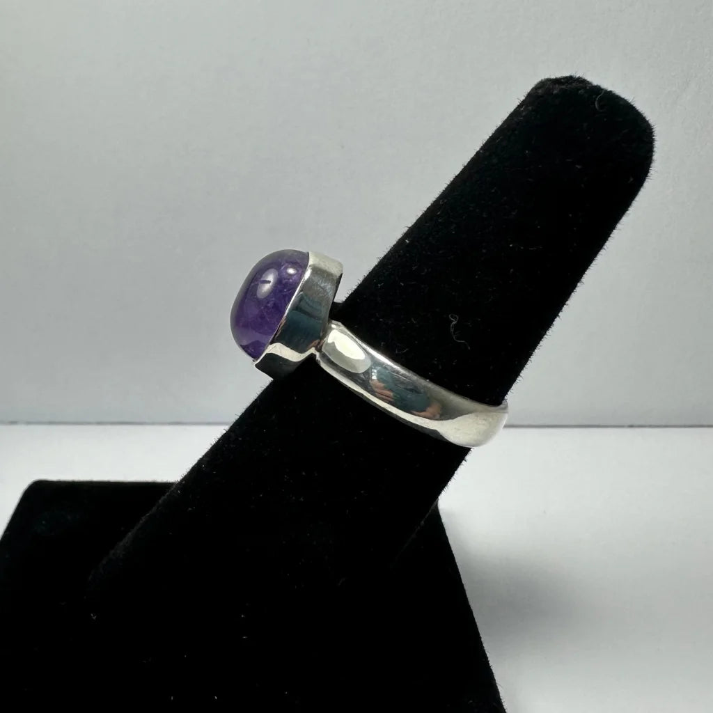 Sleek silver amethyst ring with oval purple stone in minimalist band
