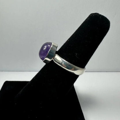 Sleek silver amethyst ring with oval purple stone in minimalist band