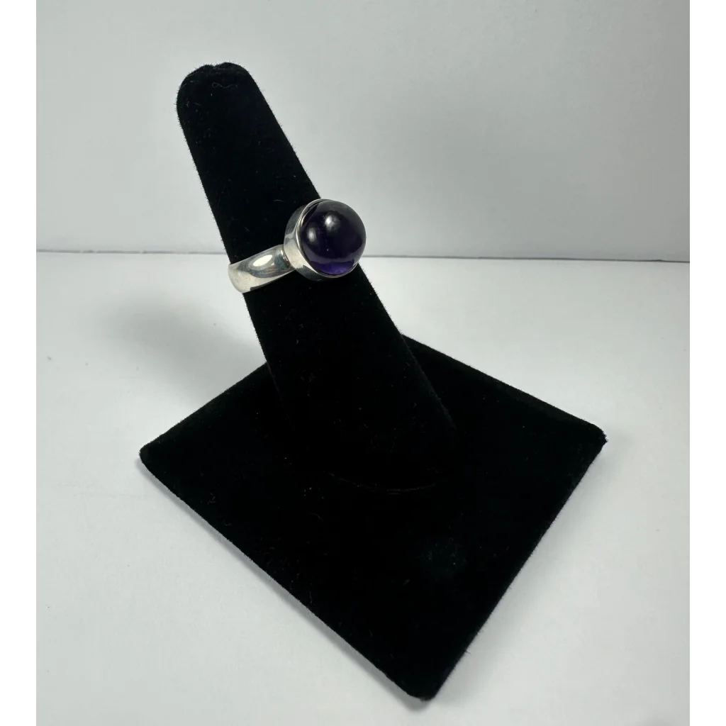 Sleek silver amethyst ring with smooth purple stone in simple band