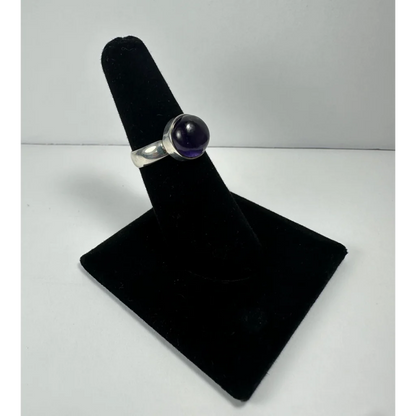Sleek silver amethyst ring with smooth purple stone in simple band
