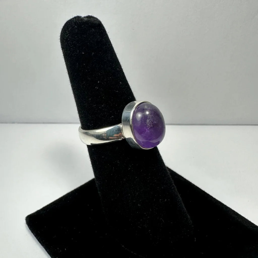 Sleek silver amethyst ring with oval purple stone in polished bezel